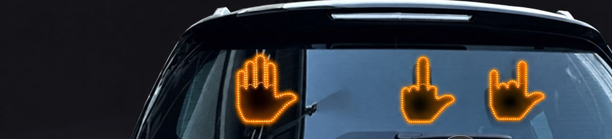 Gag Hand LED signs in a car rear window